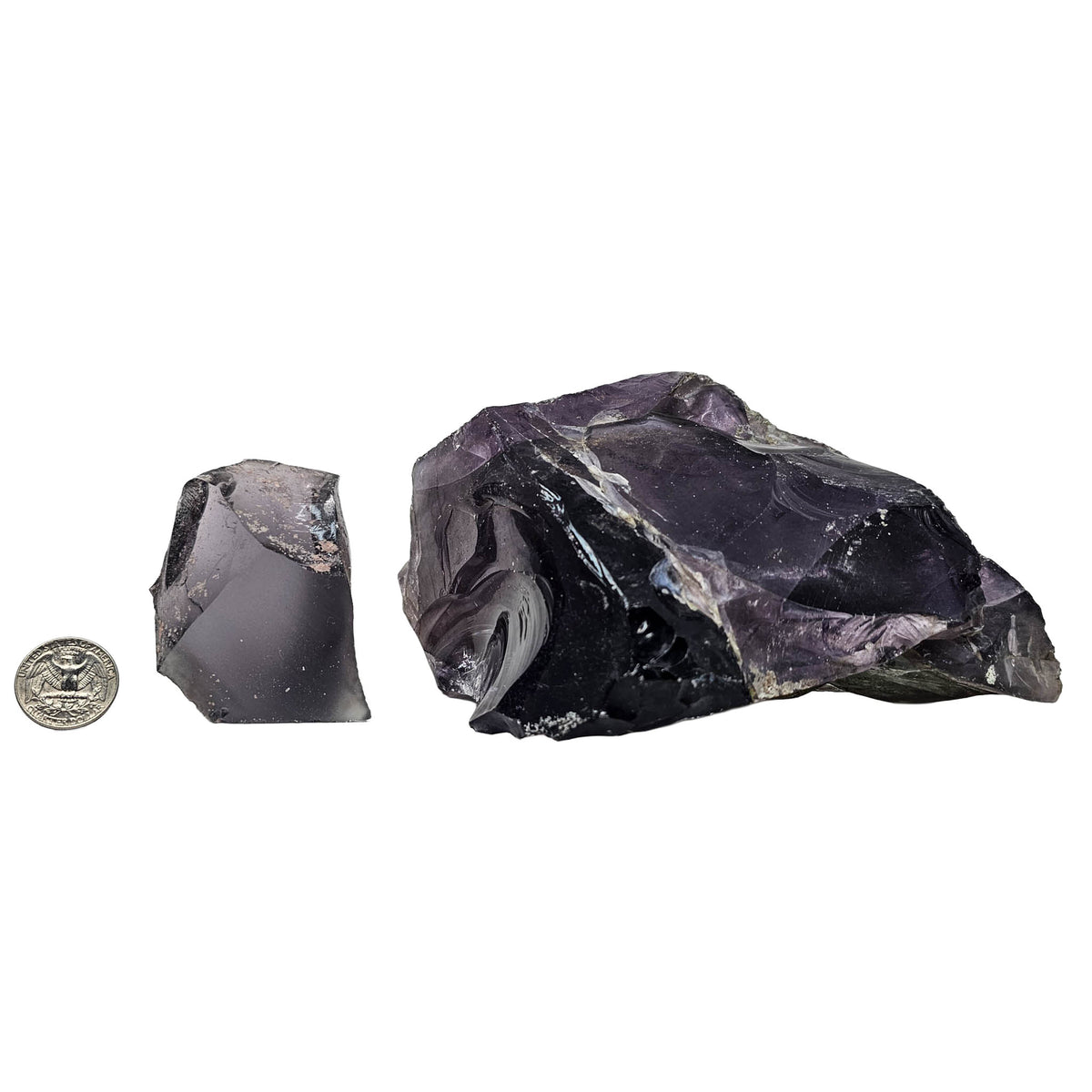 Antique glass purple rough – pieces beside a coin for scale