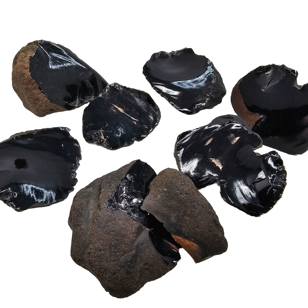 Black obsidian cobble, spalled face, Oregon – group of cobbles