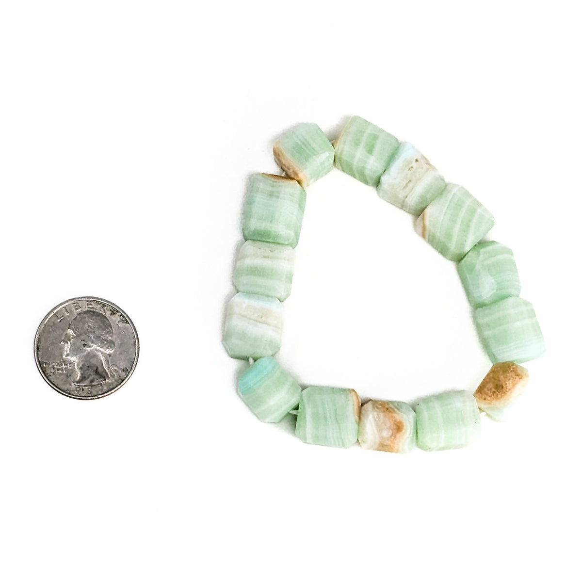 Caribbean calcite bead bracelet – bracelet beside a coin
