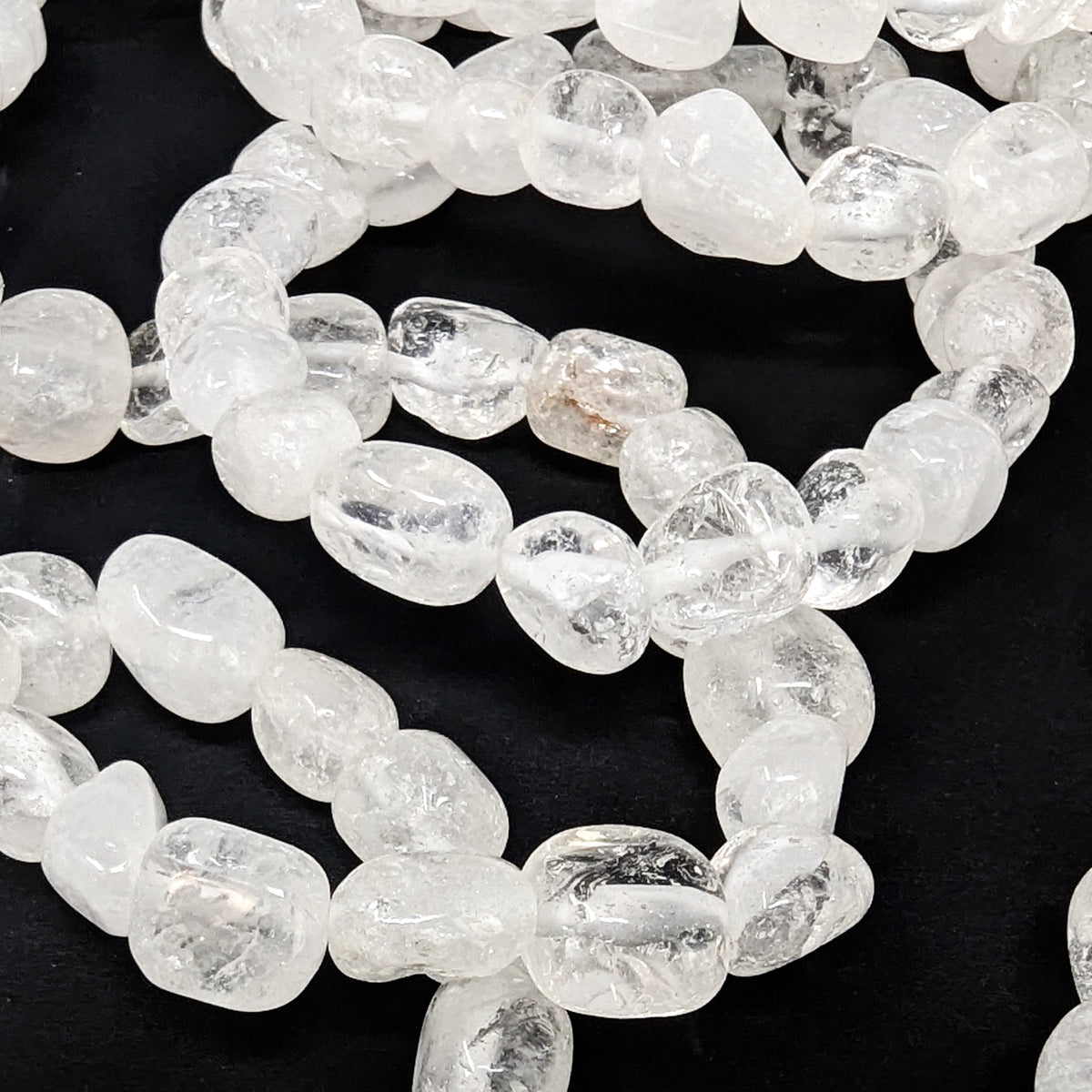 Clear quartz tumble bead bracelet – pile of bracelets