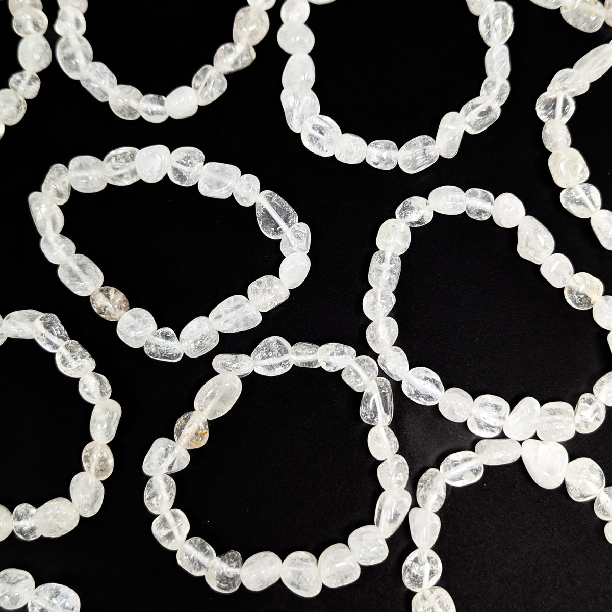 Clear quartz tumble bead bracelet – spread of bracelets