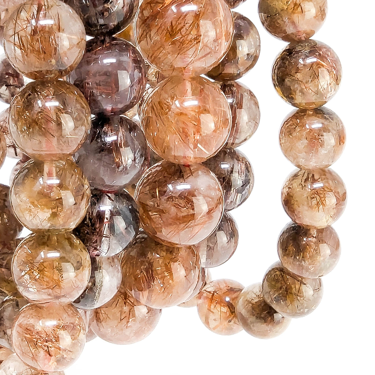Copper rutile in quartz bead bracelet from Brazil – close-up of beads with rutile needles