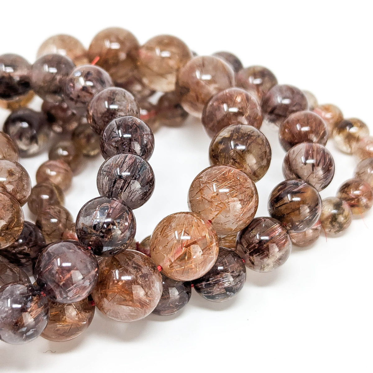 Copper rutile in quartz bead bracelet from Brazil – stack of bracelets, close view