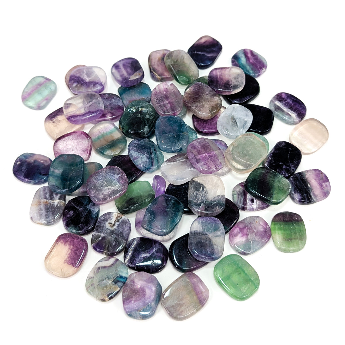 Fluorite flat tumble from China – pile of tumbles