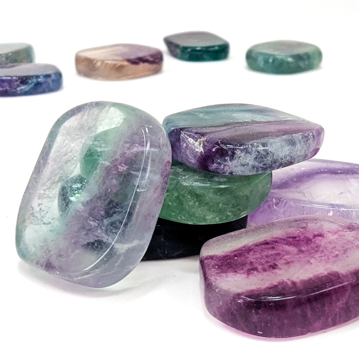 Fluorite flat tumble from China – stacked tumbles, close view