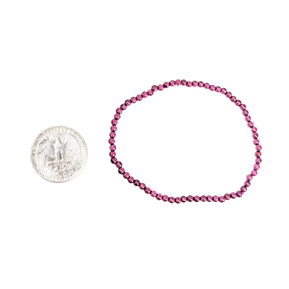 Rhodolite garnet round bead bracelet – bracelet beside a coin for scale