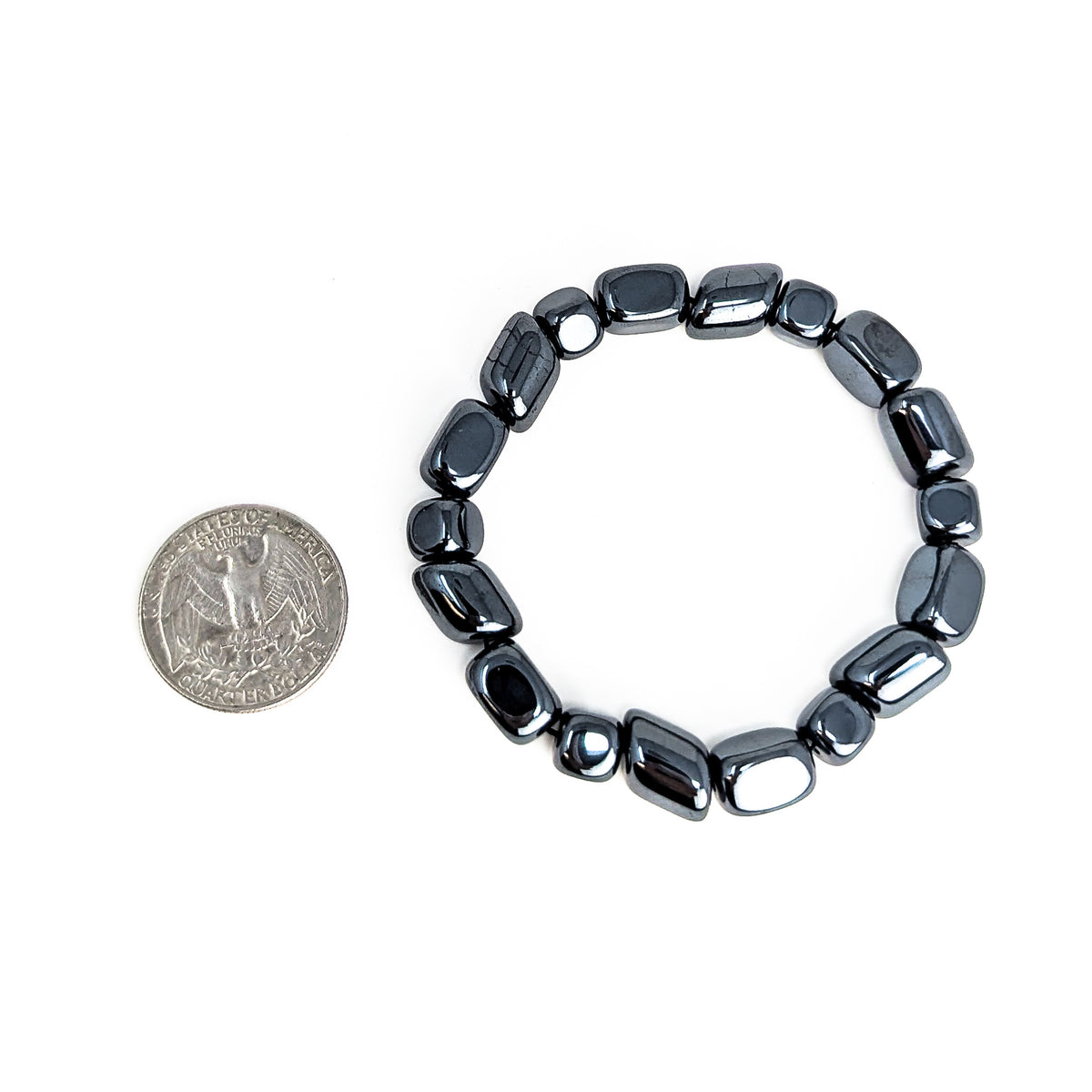 Hematite tumbled bead bracelet – bracelet beside a coin
