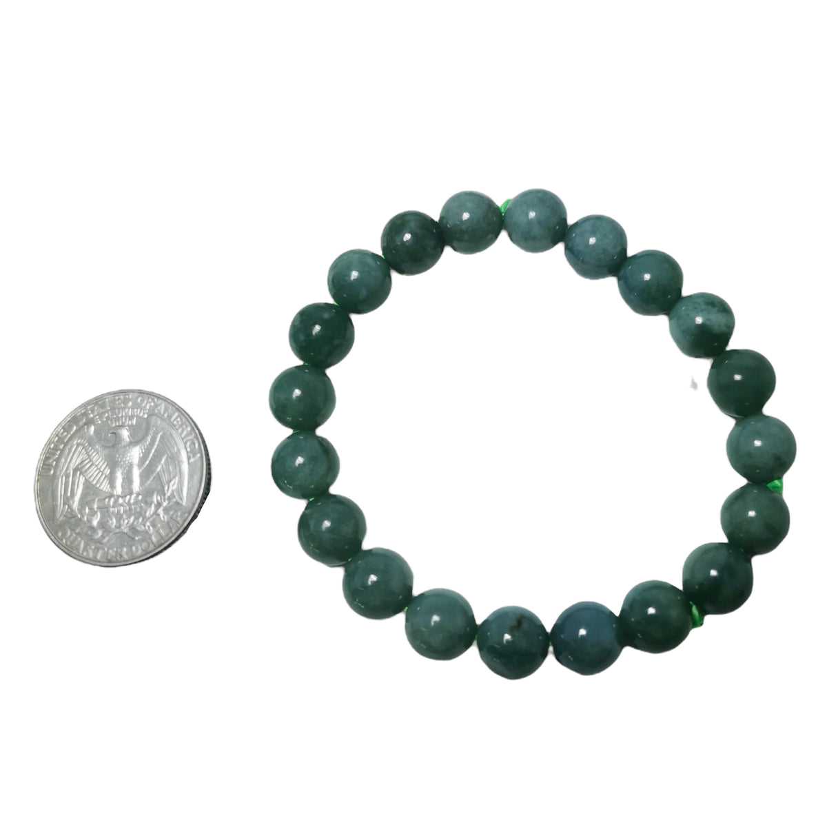 Jadeite bead bracelet from Guatemala – bracelet beside a coin for scale