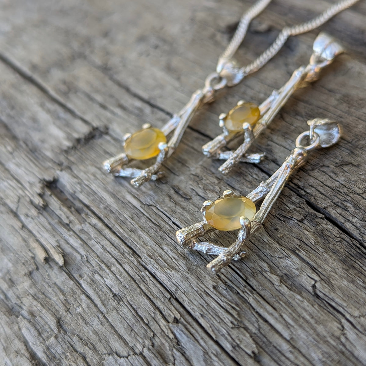 Twig and BC agate pendant: three pendants on wood
