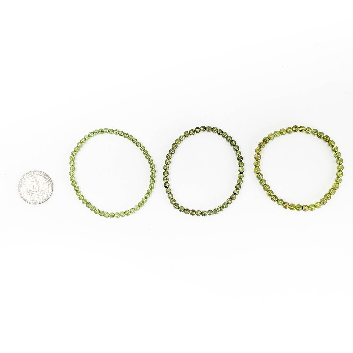 Peridot bead bracelet – three bracelets beside a coin for scale