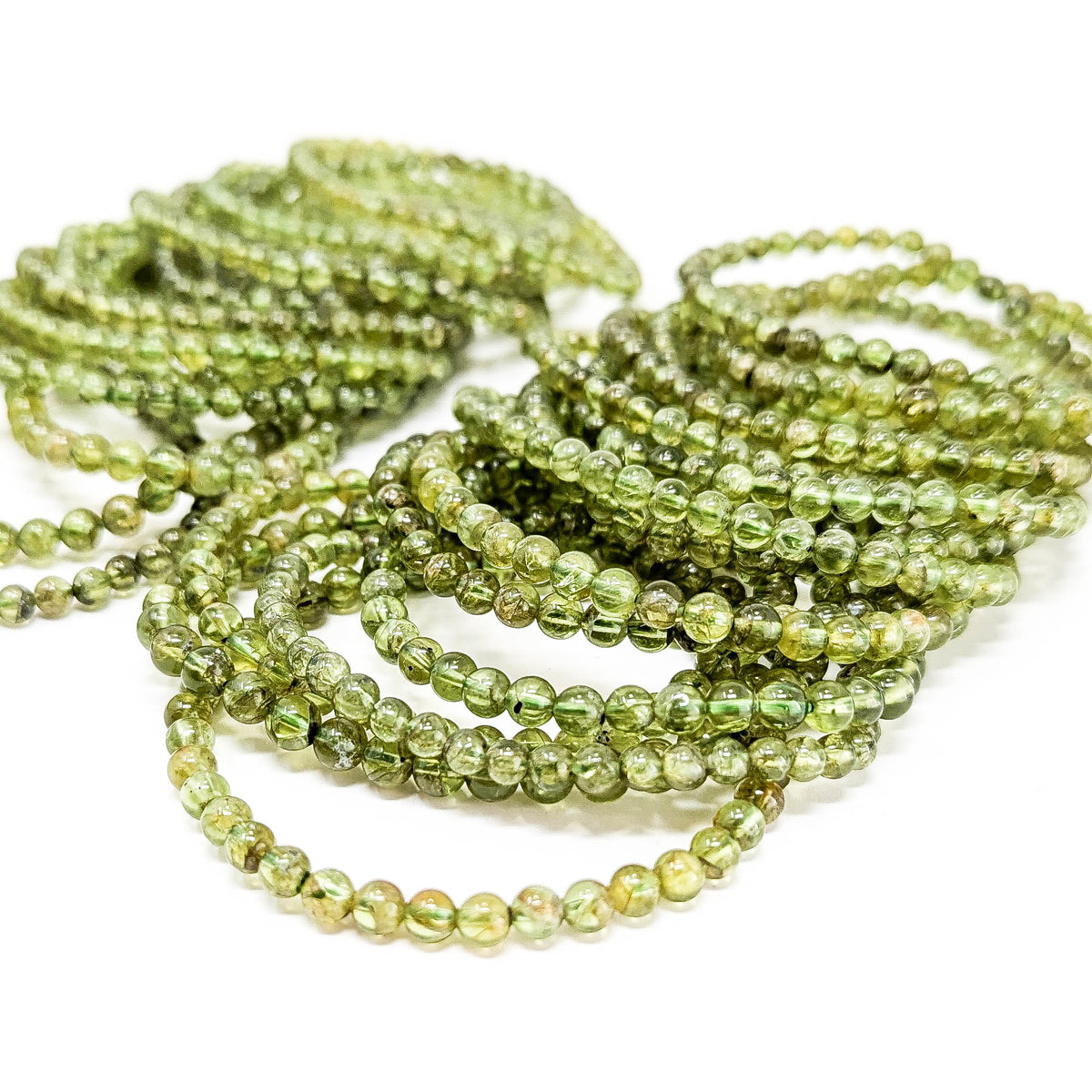 Peridot bead bracelet – pile of bracelets