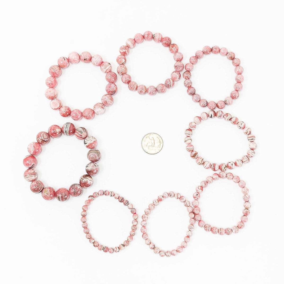 Rhodochrosite round bead bracelet – bead sizes with a coin