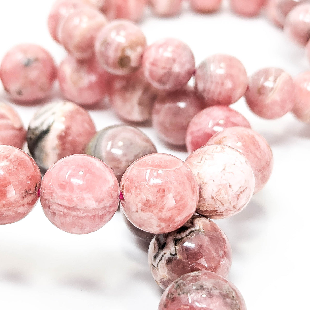 Rhodochrosite round bead bracelet – beads, close view