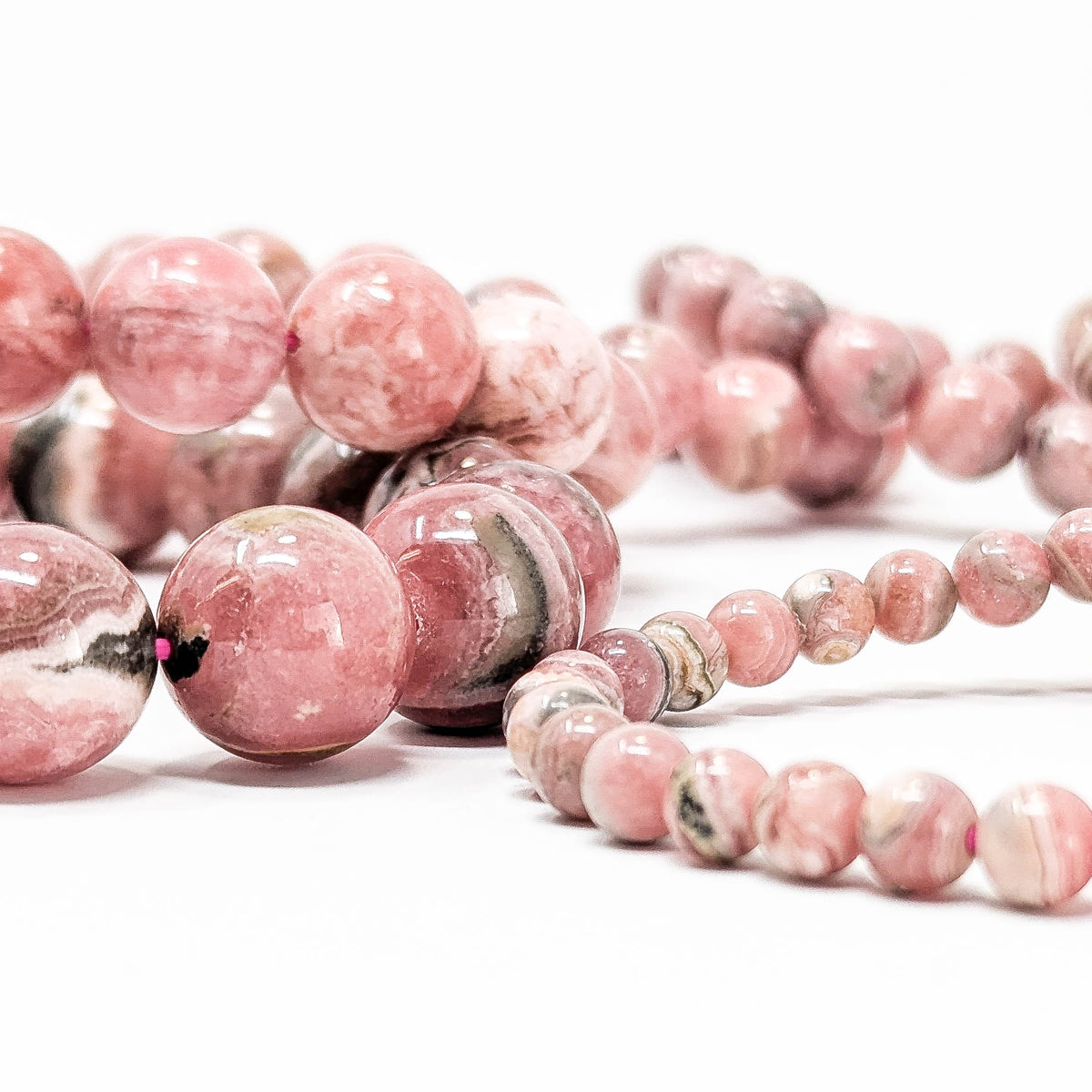 Rhodochrosite round bead bracelet – beads, side view