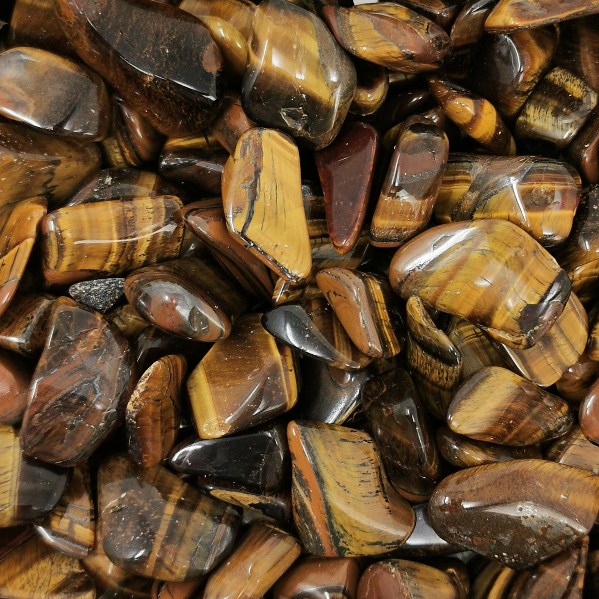 Tigers Eye tumble, a variety of quartz.