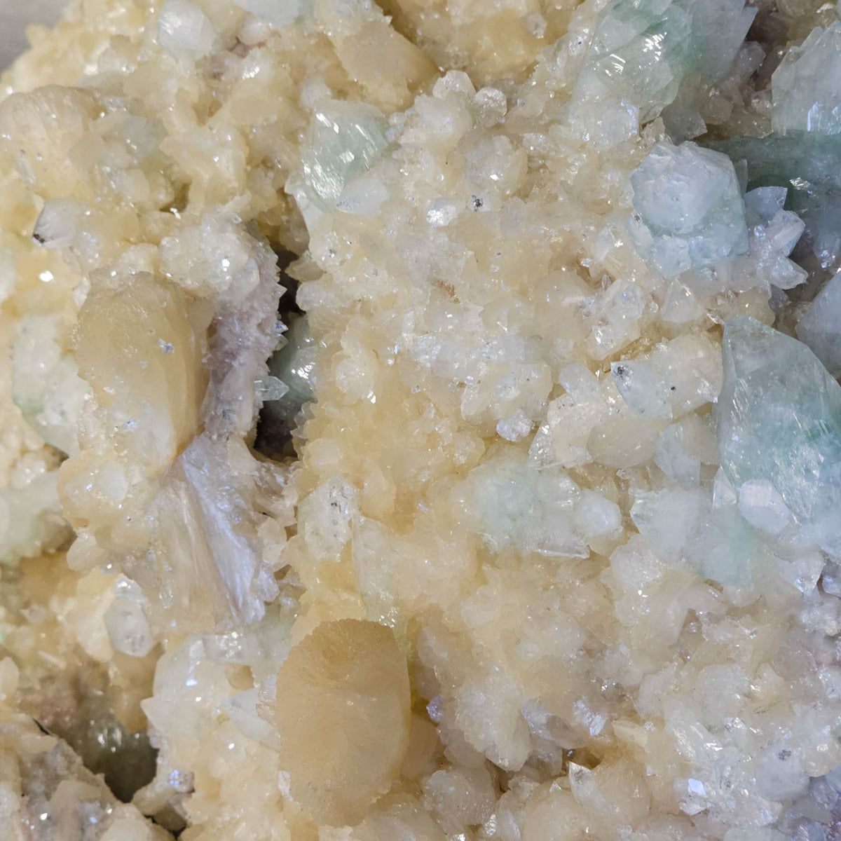 Stilbite with green apophyllite crystal cluster from Pune, India – close-up of peach stilbite and green apophyllite crystals