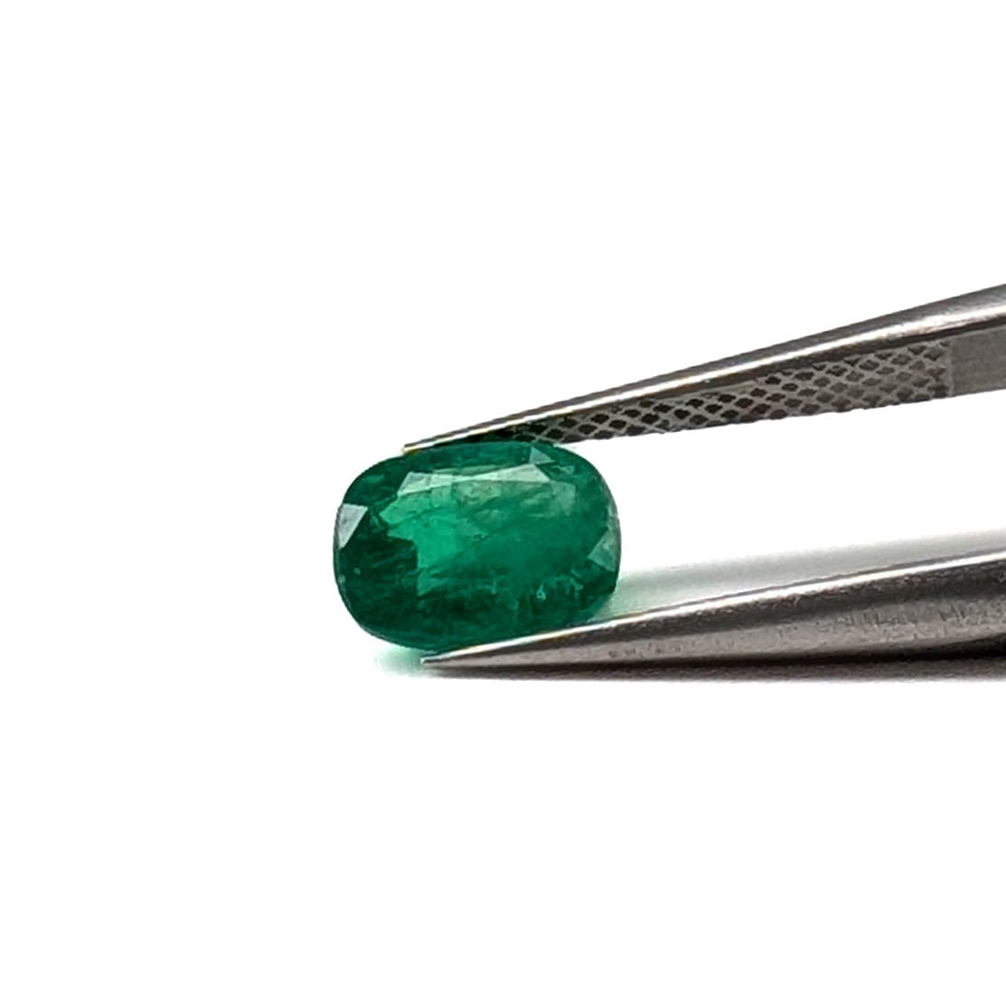 Emerald faceted cushion cut gemstone, 1.24ct, held in tweezers, view 10 of 11