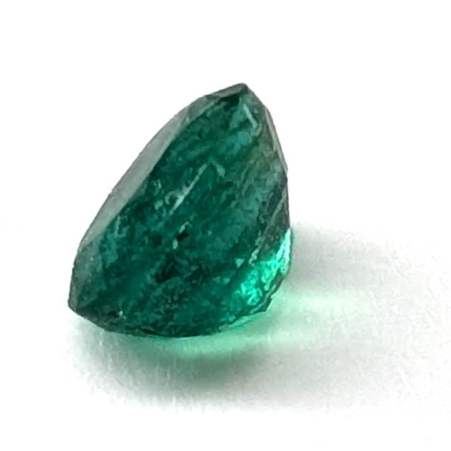 Emerald faceted oval gemstone, 0.73ct, side view of the pavilion, view 5 of 10