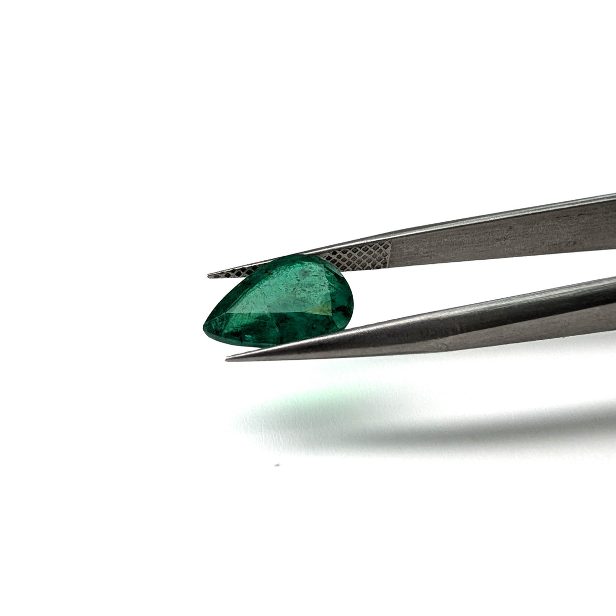 Emerald faceted pear cut gemstone, 2.36ct, held in tweezers, view 2 of 12