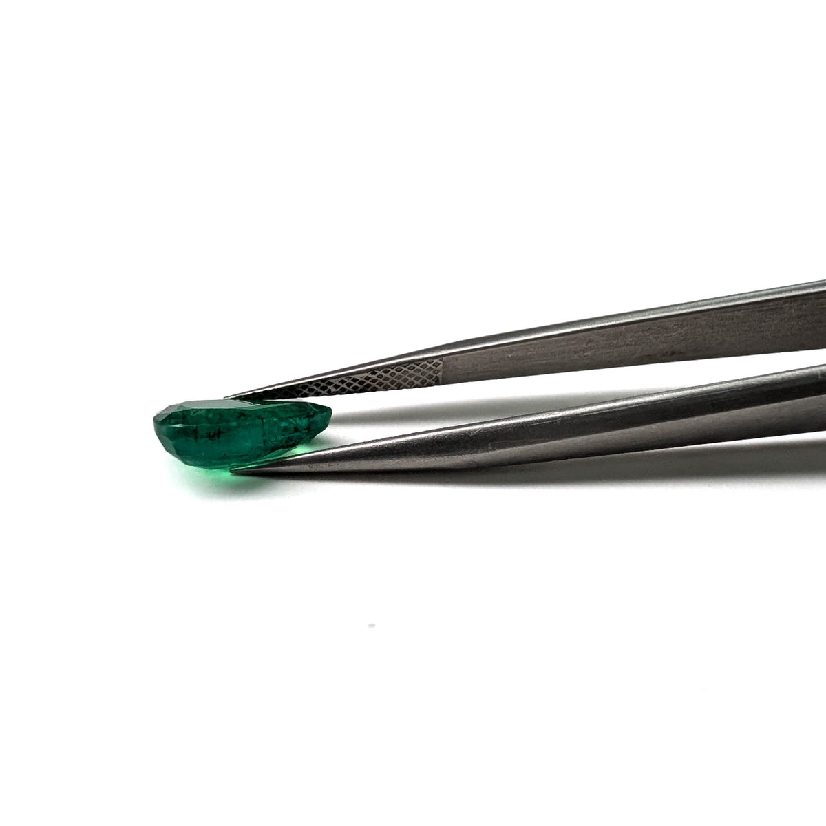 Emerald faceted pear cut gemstone, 2.36ct, held in tweezers, view 12 of 12