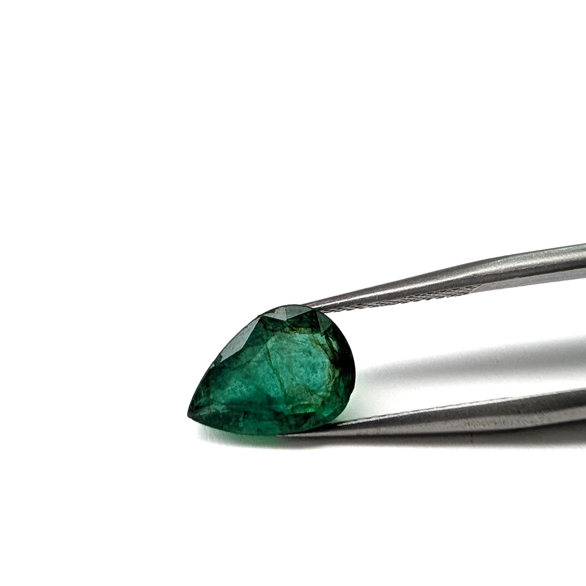 Emerald faceted pear cut gemstone, 2.47ct, held in tweezers, view 15 of 17