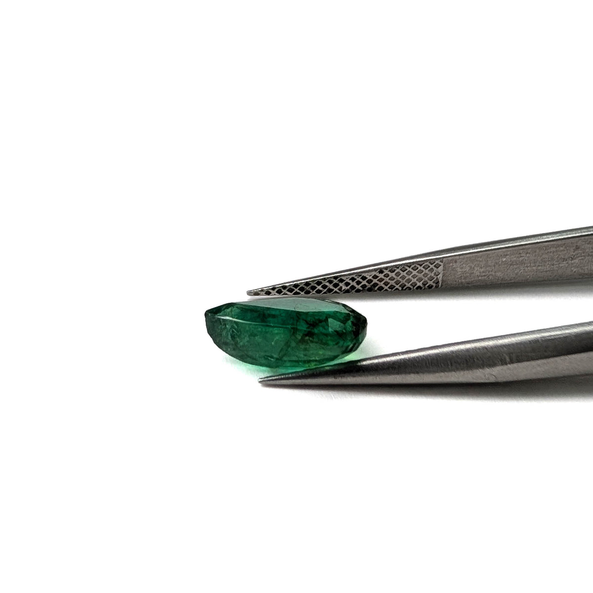Emerald faceted pear cut gemstone, 2.47ct, held in tweezers, view 17 of 17