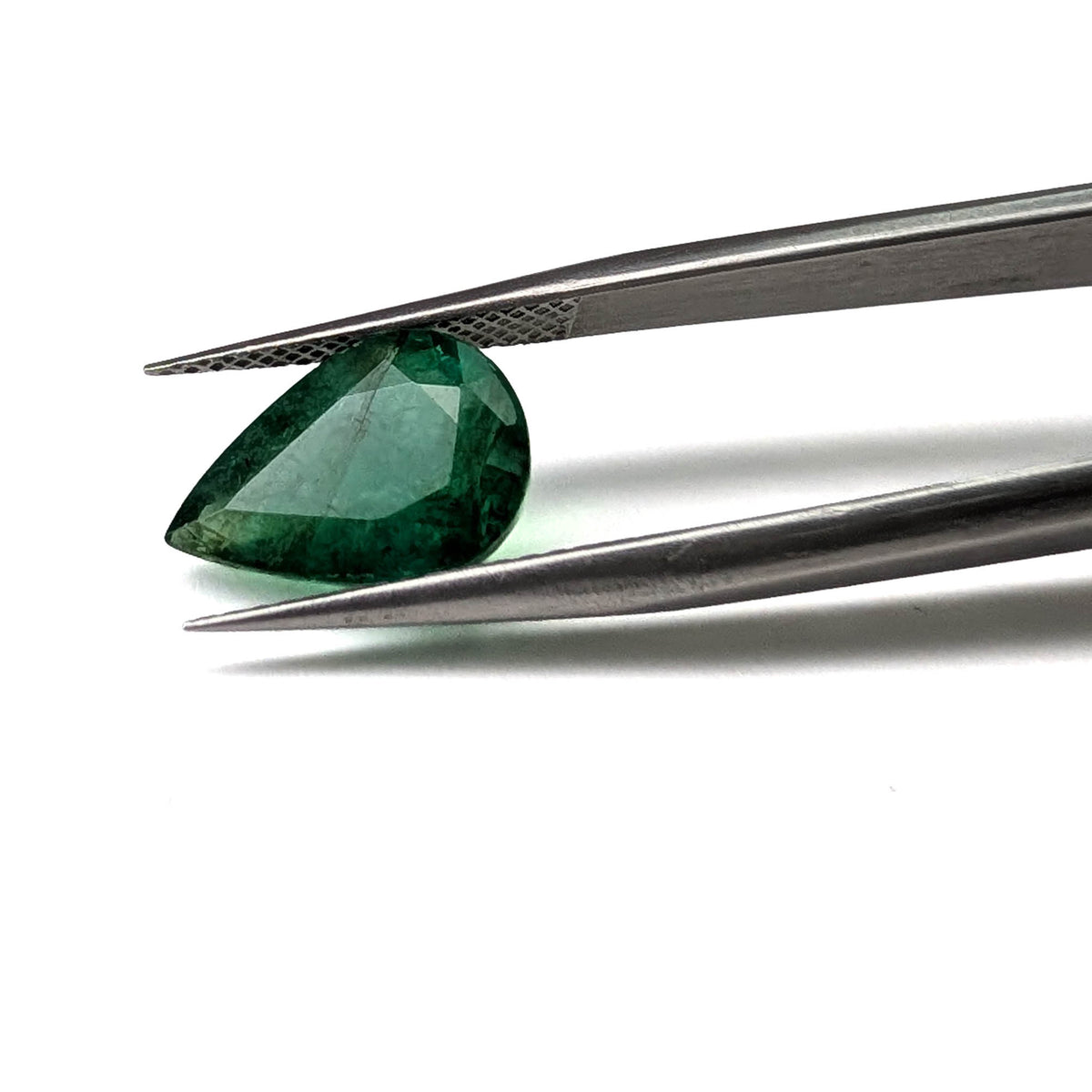 Emerald faceted pear cut gemstone, 3.50ct, held in tweezers, view 10 of 11