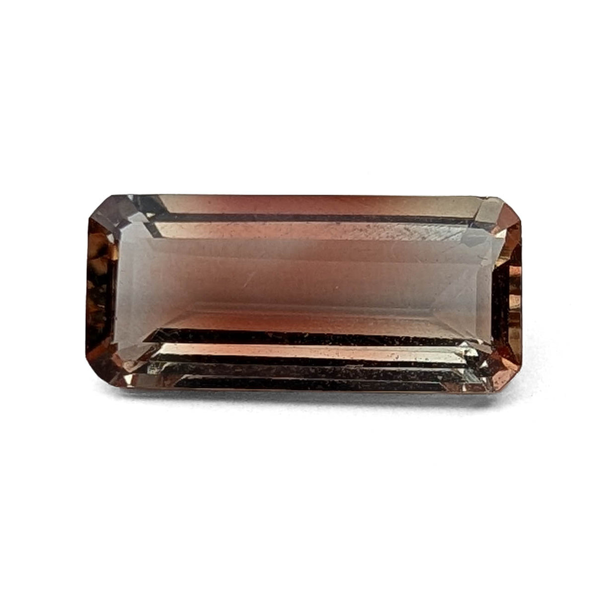 Oregon sunstone faceted emerald gemstone, 3.18ct, on a white background, view 1 of 9