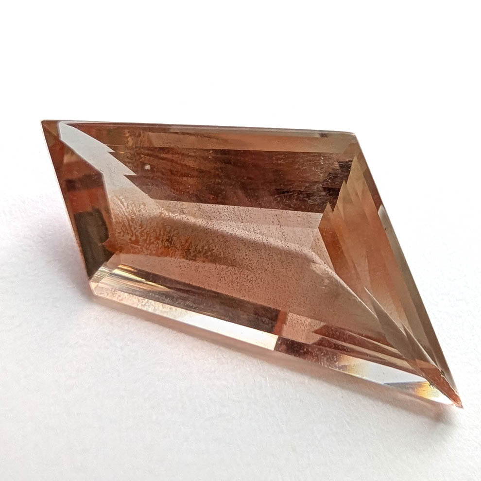 Oregon Sunstone faceted freeform step cut gemstone, 5.50ct, from Plush, Oregon, on a white background, view 1 of 8