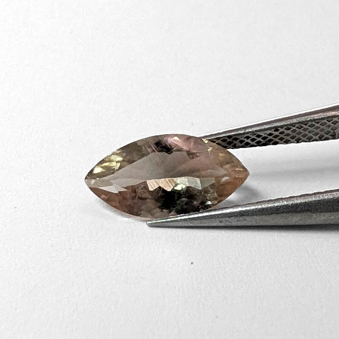 Oregon Sunstone faceted marquise cut gemstone, 1.49ct, from Plush, Oregon, held in tweezers, view 2 of 8