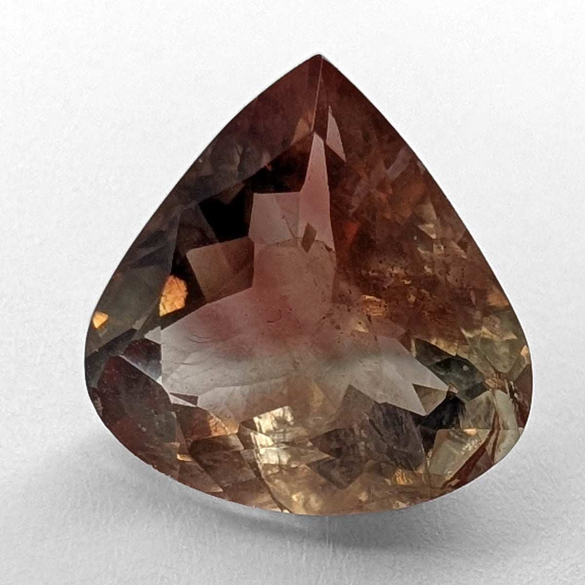 Oregon Sunstone faceted pear cut gemstone, 5.21ct, from Plush, Oregon, on a white background, view 1 of 12