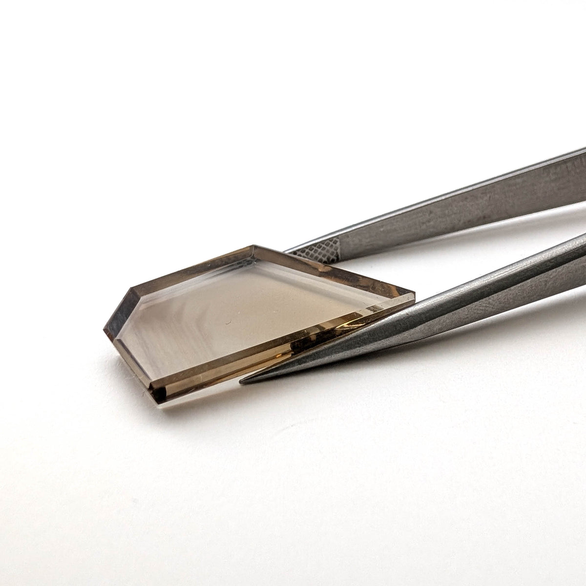 Smoky Quartz faceted freeform flatback step cut gemstone, 10.51ct, from Minas Gerais, Brazil, held in tweezers, view 2 of 6