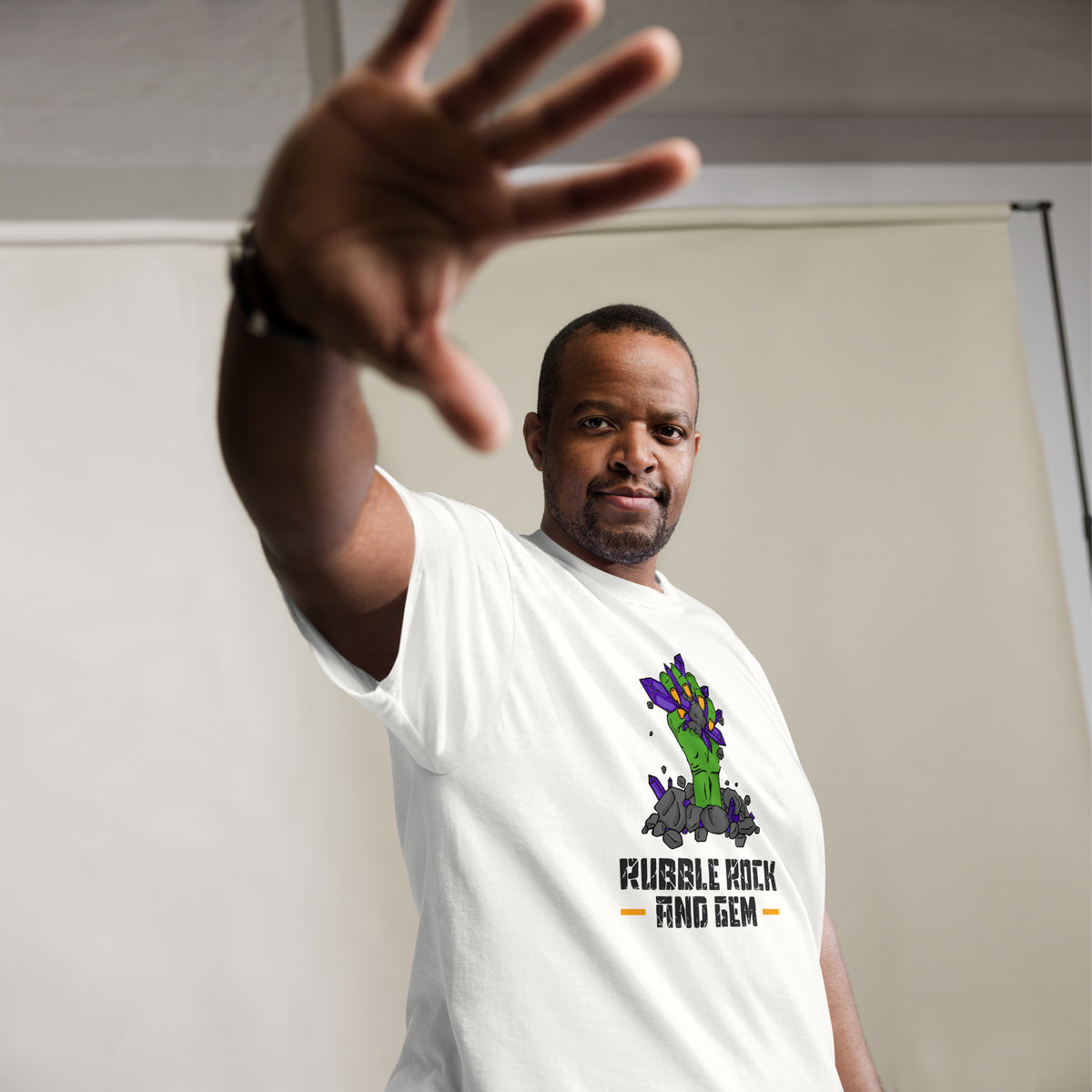 Rubble Rock and Gem classic logo tee – worn by man, hand raised