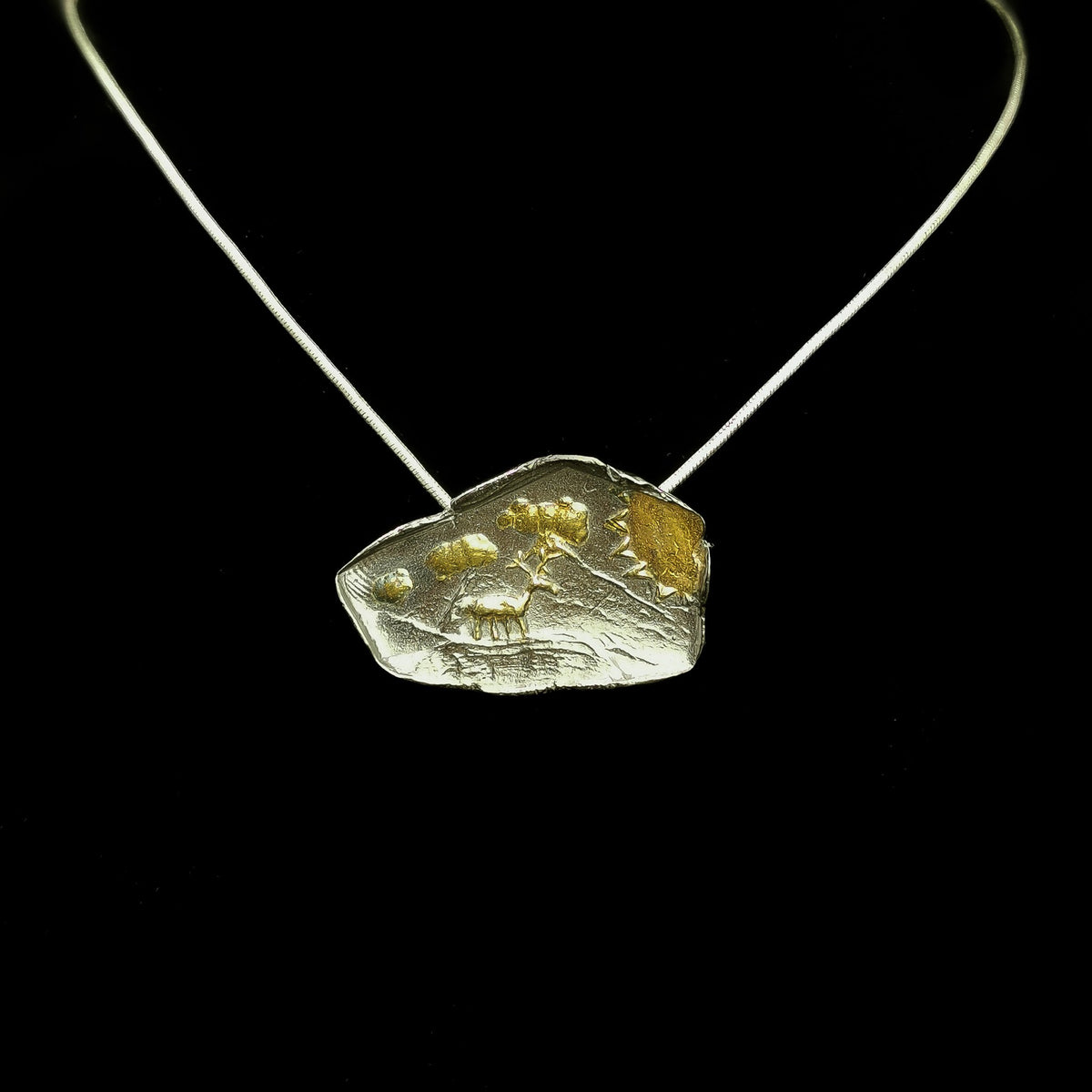 Caribou pendant.