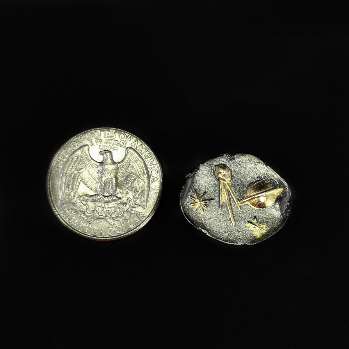 Comet pendant: pendant beside a coin for scale