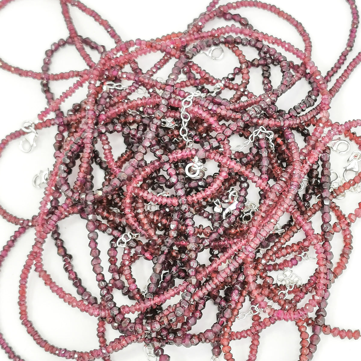 Garnet facet bead necklace in sterling silver and steel wire.