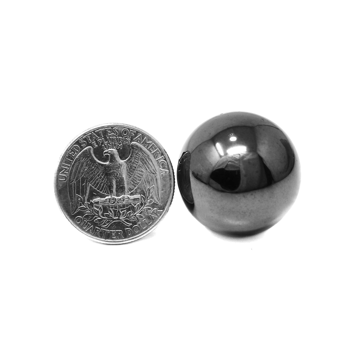 Man-made hematite mini sphere: sphere beside a coin for scale