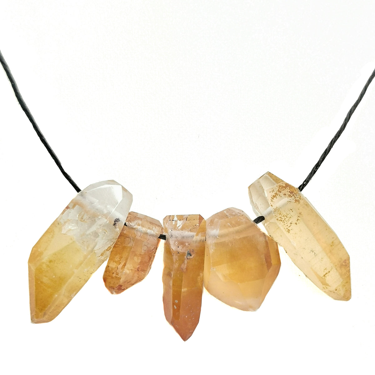 Mandarin quartz point pendant: drilled hole close up