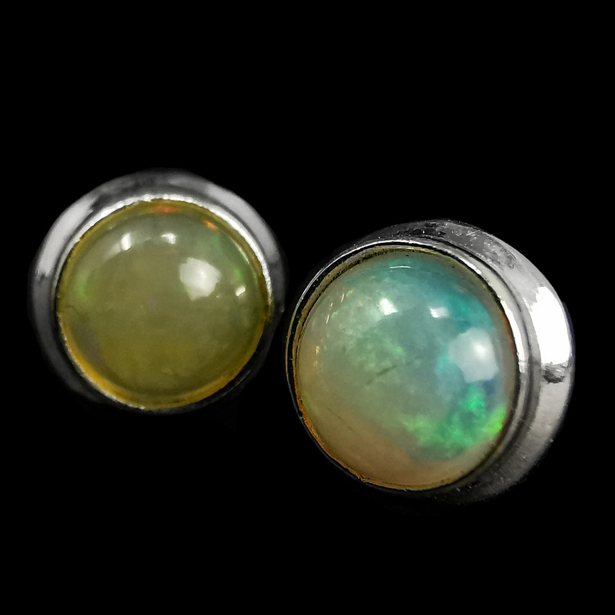 Ethiopian opal round stud earrings – pair, close-up of opal flash