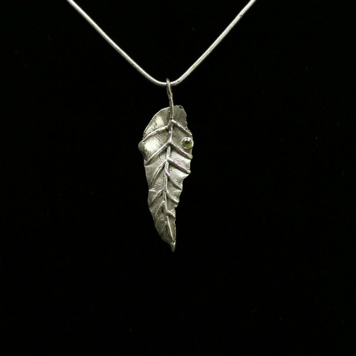 Peridot Leaf pendant in sterling silver with Faceted Peridot.