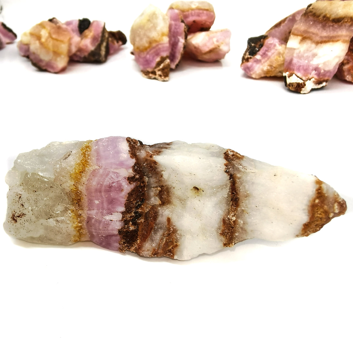 Pink calcite, Pakistan: group with a large banded piece