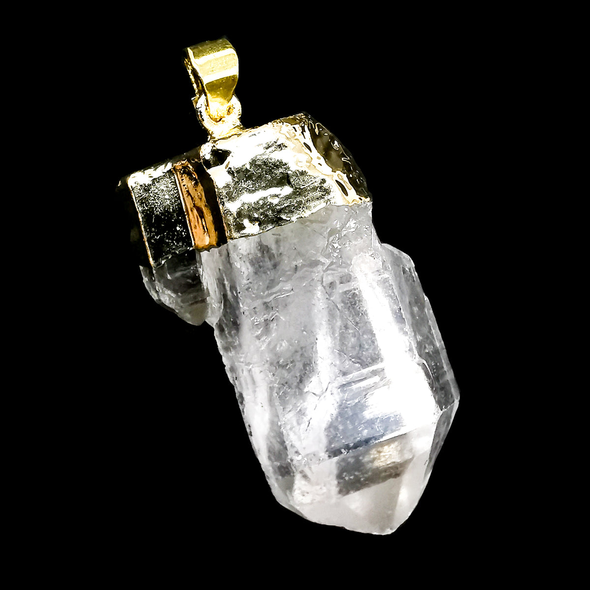 Raw clear quartz point pendant – close-up of a point