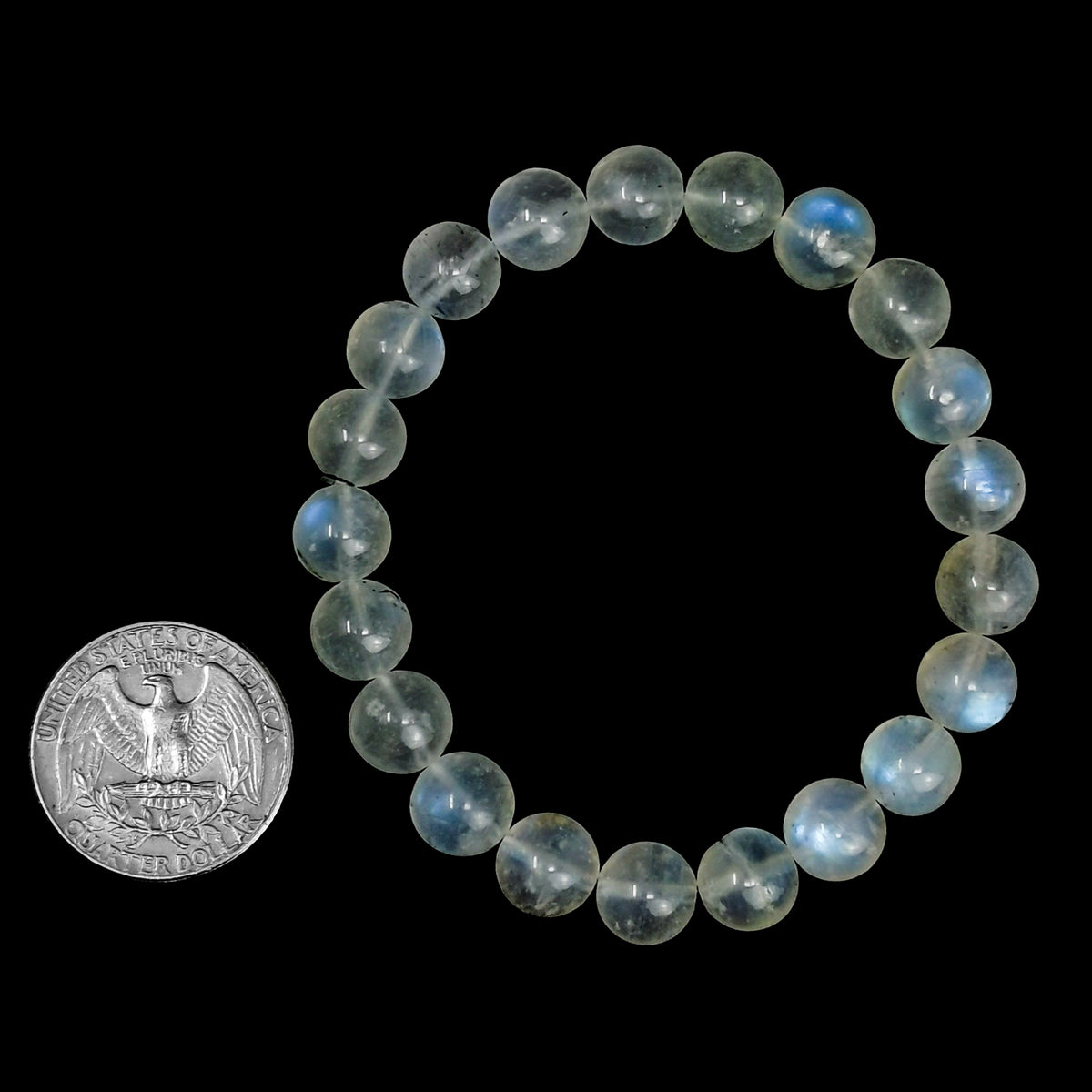 Rainbow moonstone bead bracelet – bracelet beside a coin for scale