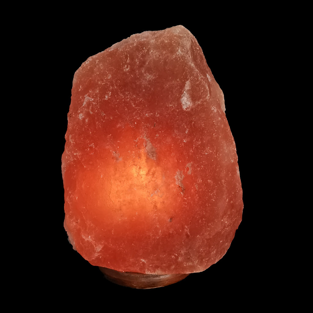 Himalayan salt lamp lit by a light cord, angled view