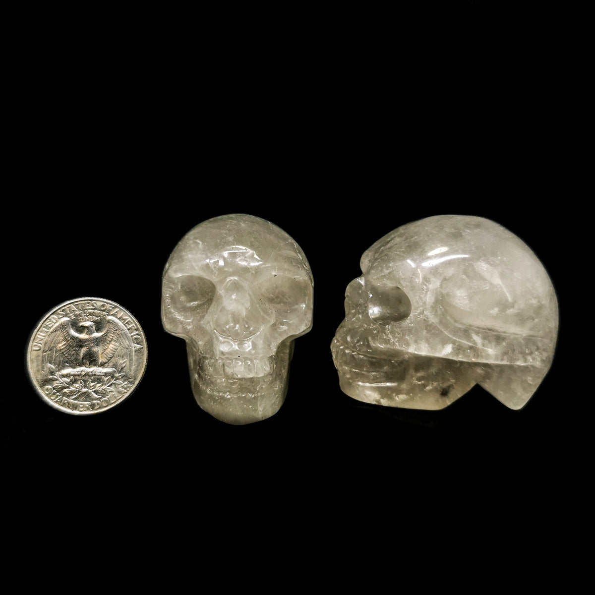 Smoky quartz skull: two skulls beside a coin for scale