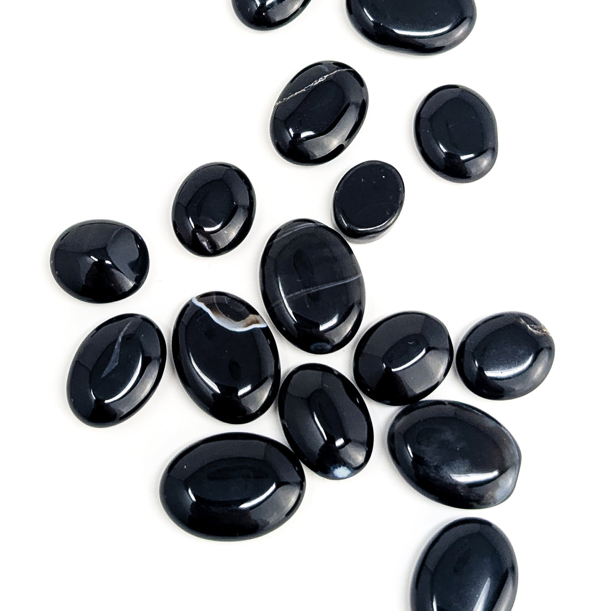 Black onyx oval tumble from Brazil – scattered ovals