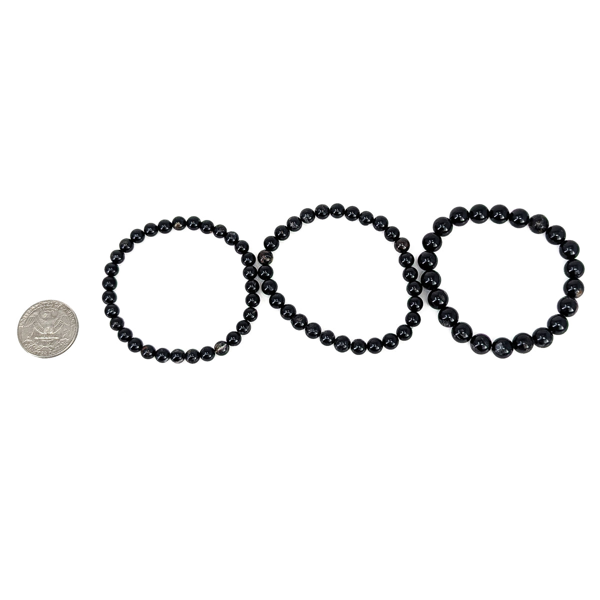 Black tourmaline bead bracelet: three sizes beside a coin for scale