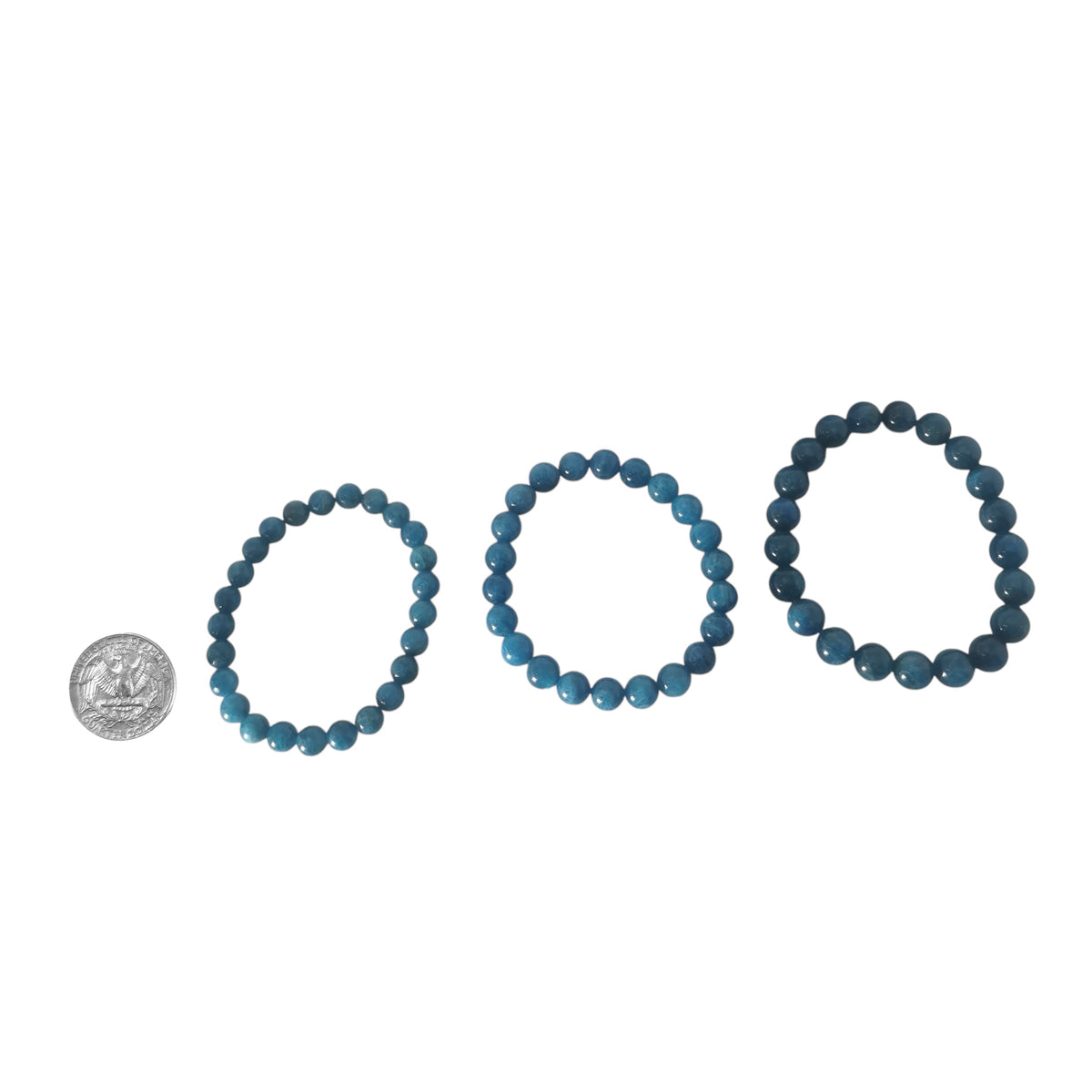 Blue apatite round bead bracelet – three sizes beside a coin for scale