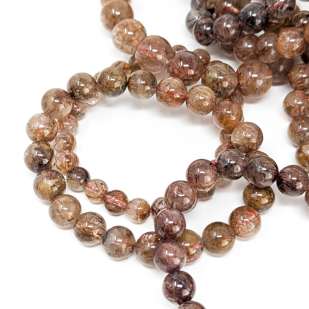 Copper rutile in quartz bead bracelet from Brazil – loose stack of bracelets