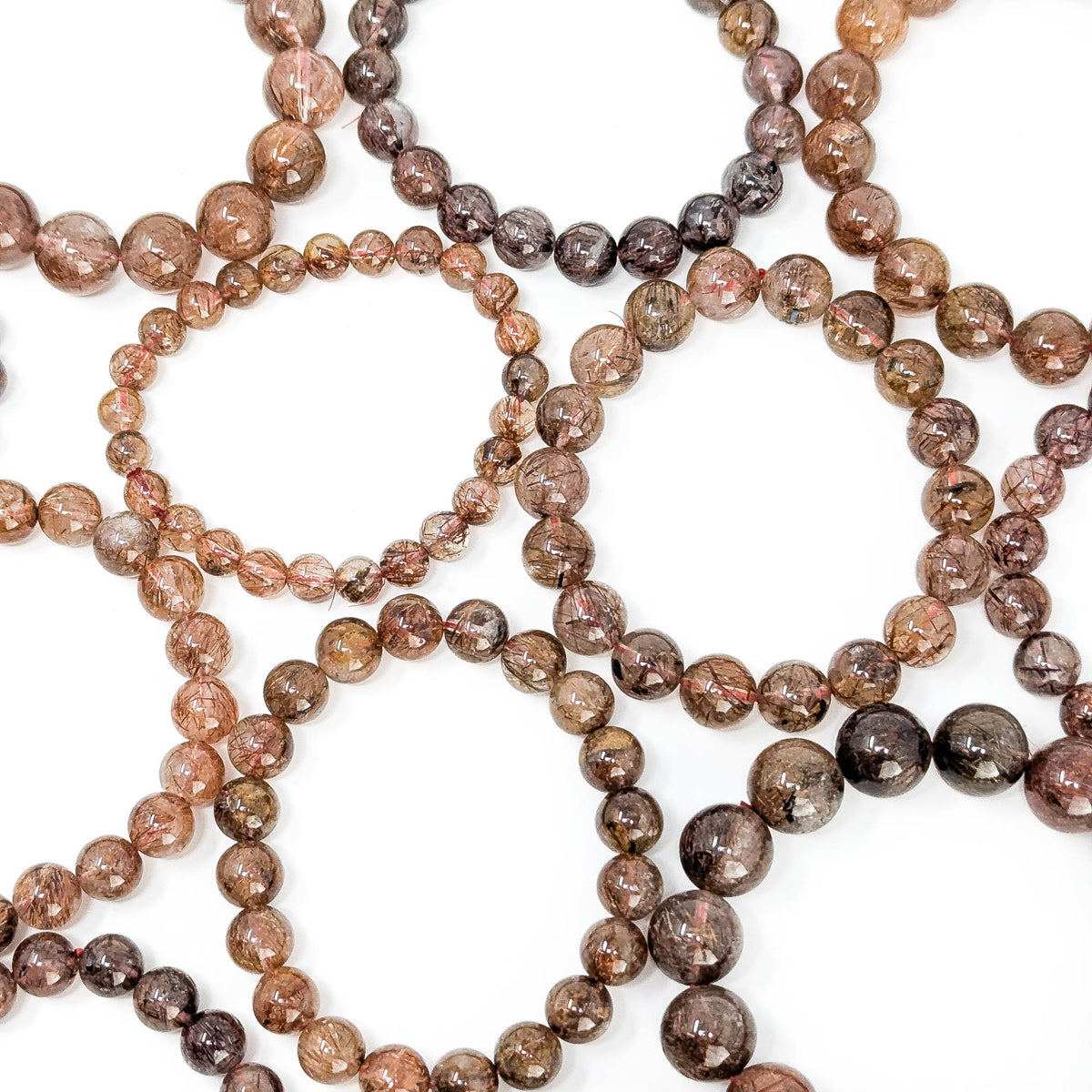 Copper rutile in quartz bead bracelet from Brazil – overlapping bracelets, top view